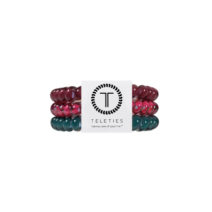 Set of three Harvest Hues Small Hair Ties in maroon, pink, and teal with a white TELETIES brand card displaying the logo and “taking care of your hair” slogan. Available in small size.