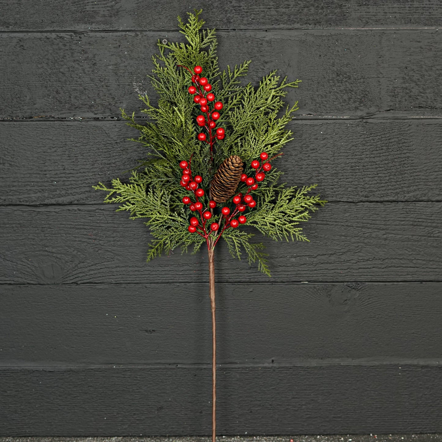 The Superior Real Touch Mix Cedar is a festive 29-inch branch with lifelike cedar sprigs, green pine branches, a small pine cone, and vibrant red berries on a single stem. Available in 29-inch size.