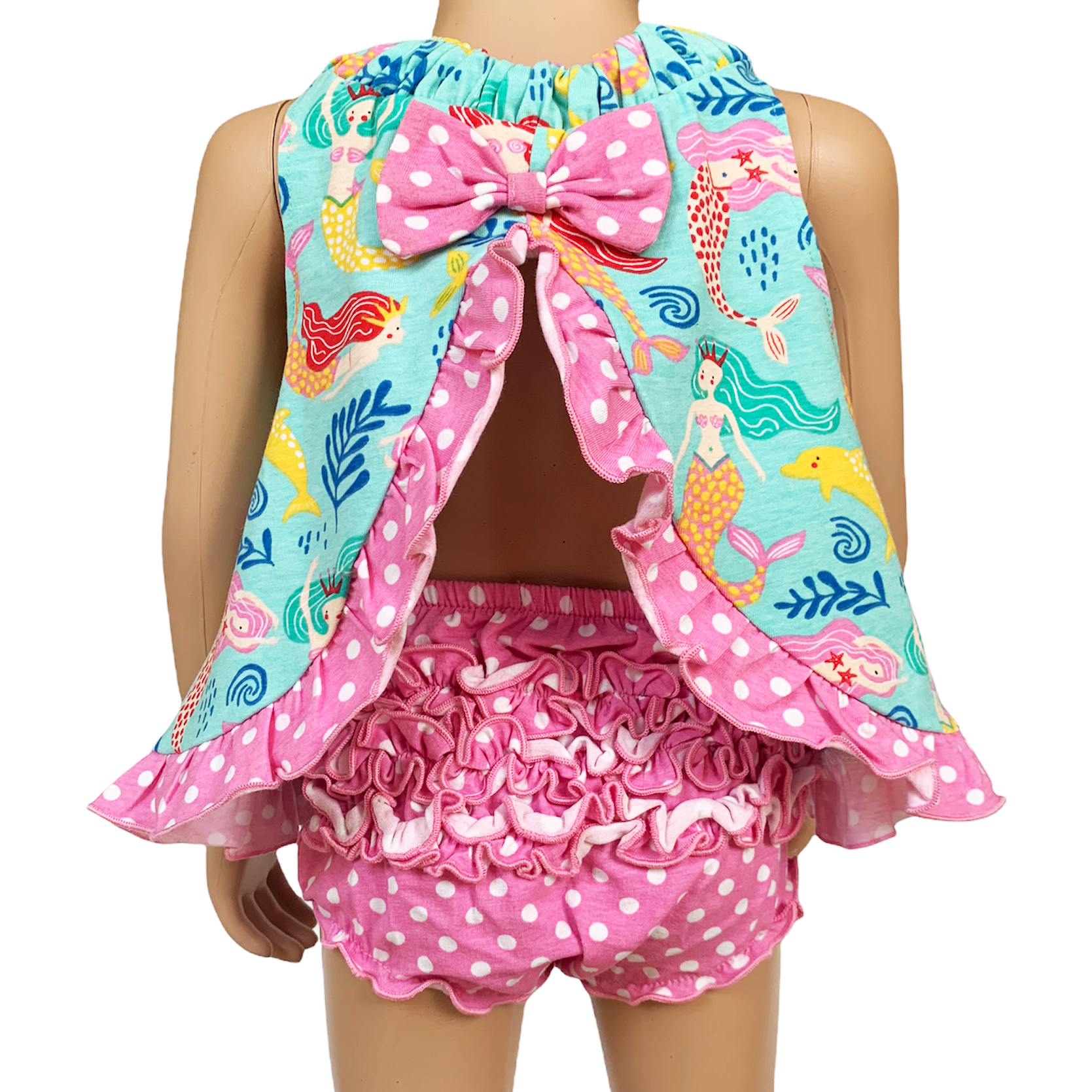 A mannequin displaying a child's swimsuit set, featuring the Pink Polka Dot Knit Ruffled Baby Bloomers: 12-24 mo and a colorful mermaid and sea life patterned scarf with a bow at the neck.