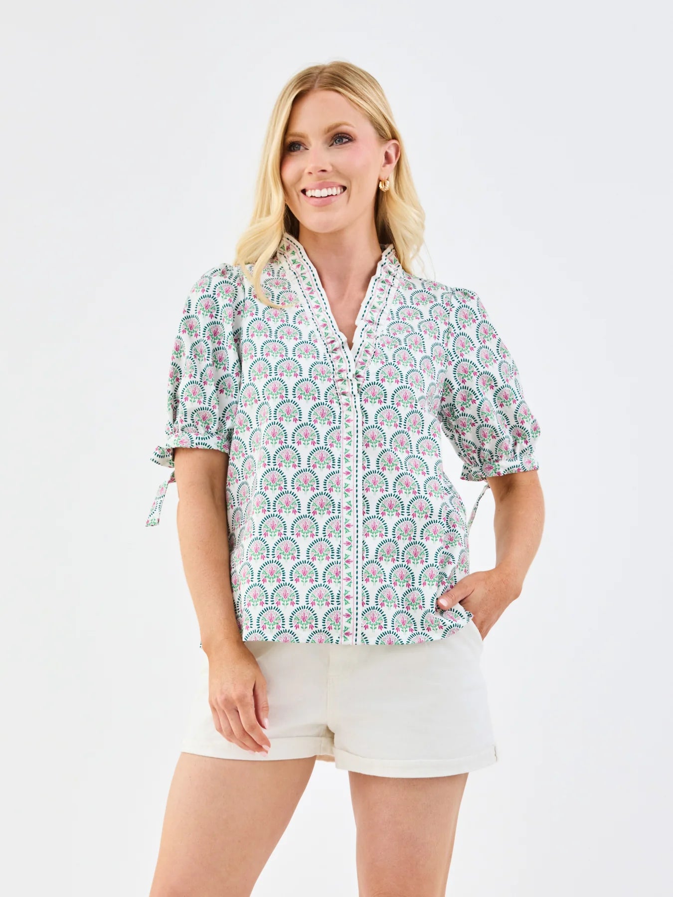 Brynn Sunshower Flora White Top: v-neck, patterned short sleeves, white trim. Available in sizes XS-XL.