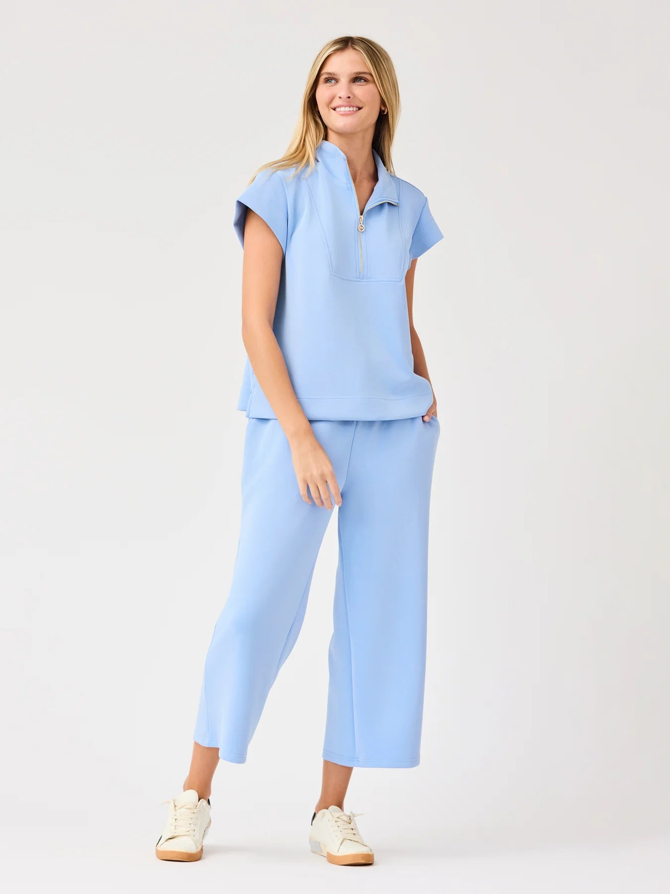 Stephie Top in light blue: short-sleeve zip-up, pop collar. Available in sizes XS–XL.