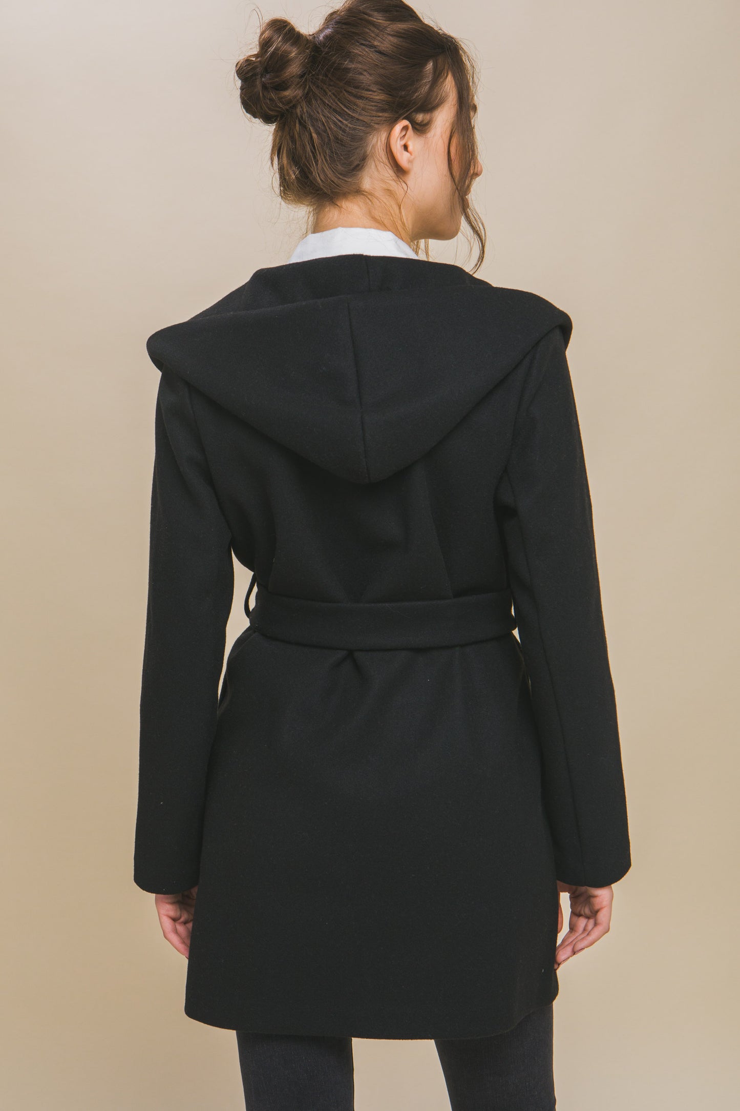 The Fleece Belted Hoodie Coat in black offers a cozy fit with a waist belt for added style. Available sizes: XS, S, M, L, XL.