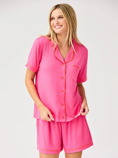 Charlotte Pink Shorts Set: bright pink short-sleeve pajama with orange trim, button-up top, matching shorts. Sizes XS-XL.