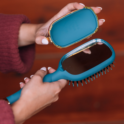 Boar Bristle Hair Brush - Teal With It shown with built-in mirror, glossy teal finish, gold accents, and matching teal case. Available in small and large sizes.