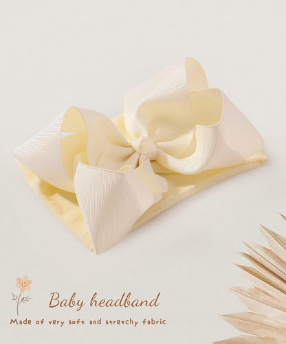 Pale yellow bow headband for infants & toddlers with large textured bow, soft stretchy fabric. Available in multiple sizes.