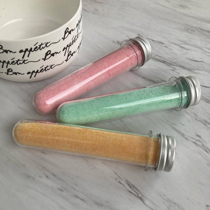 Three transparent tubes of Cocktail Mix Shots in pink, green, and yellow. Available sizes: 50ml, 100ml.