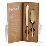 Gold-tone two-piece cake serving set with knife and spatula in a brown presentation box with white ribbon.