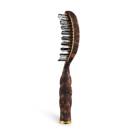 Brown tortoiseshell-patterned vented hair brush with gold accents, curved handle, plastic bristles with rounded tips, and quick-heat aluminum plate. Available in standard and travel sizes.