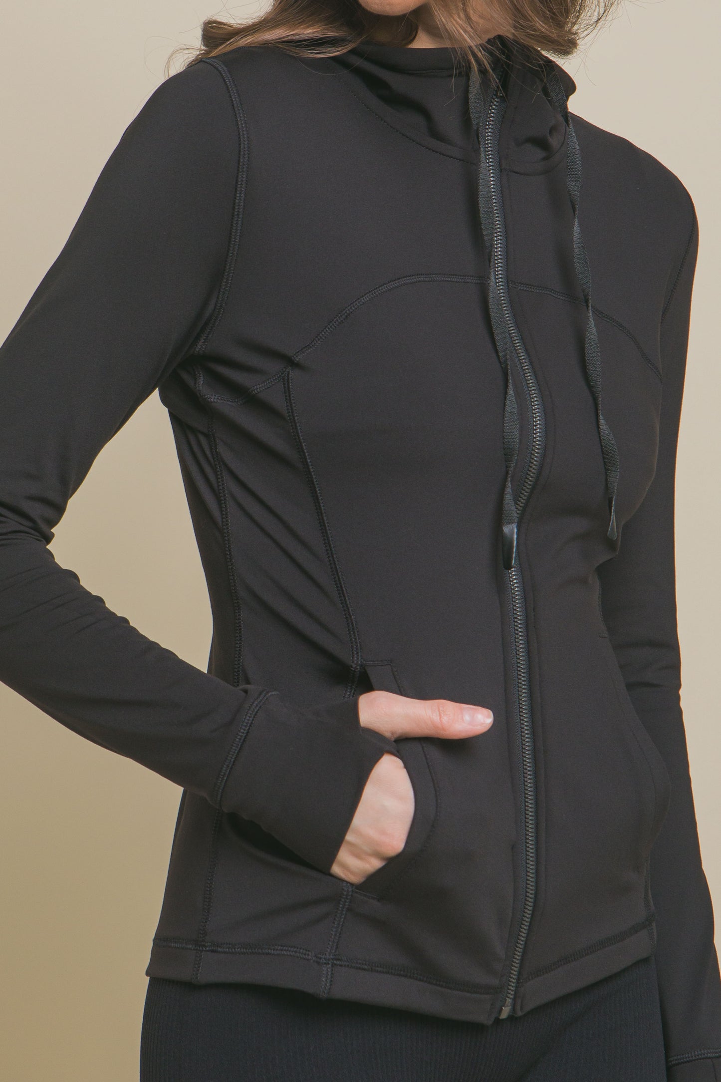 The Solid Knit Performance Activewear Jacket in black features buttery soft fabric, a zipper closure, and a hood. It includes long sleeves with thumbholes and side pockets. Available sizes: S, M, L, XL.