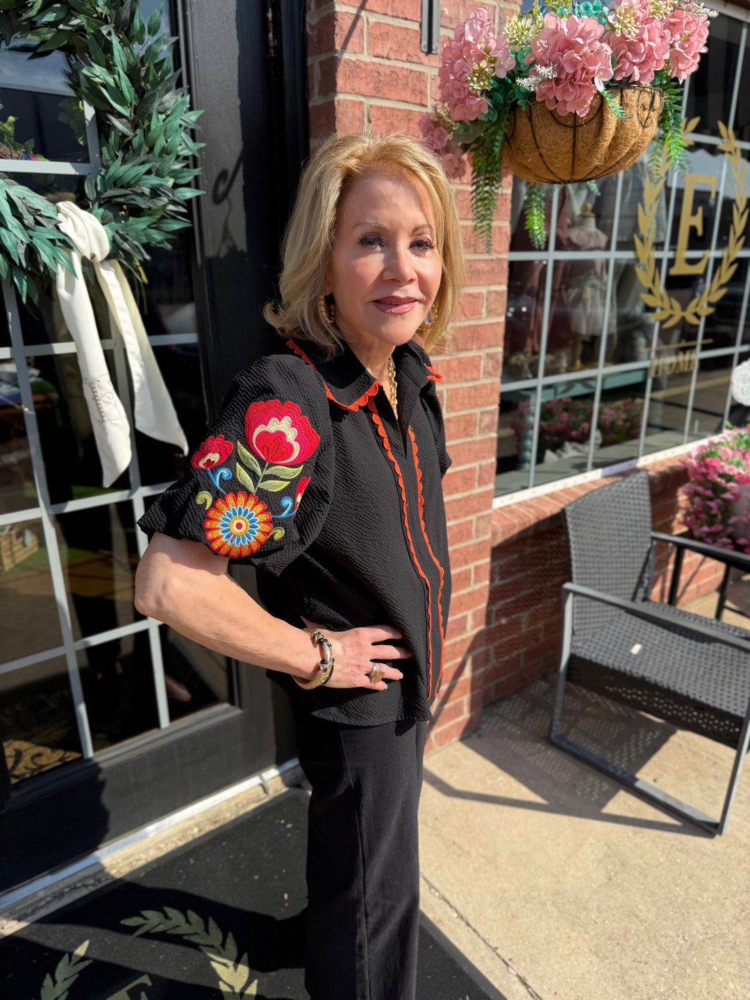 Fall in Bloom Blouse with colorful floral sleeves; available in sizes S-XL.