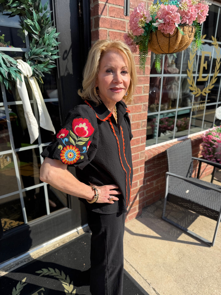 Fall in Bloom Blouse with colorful floral sleeves; available in sizes S-XL.