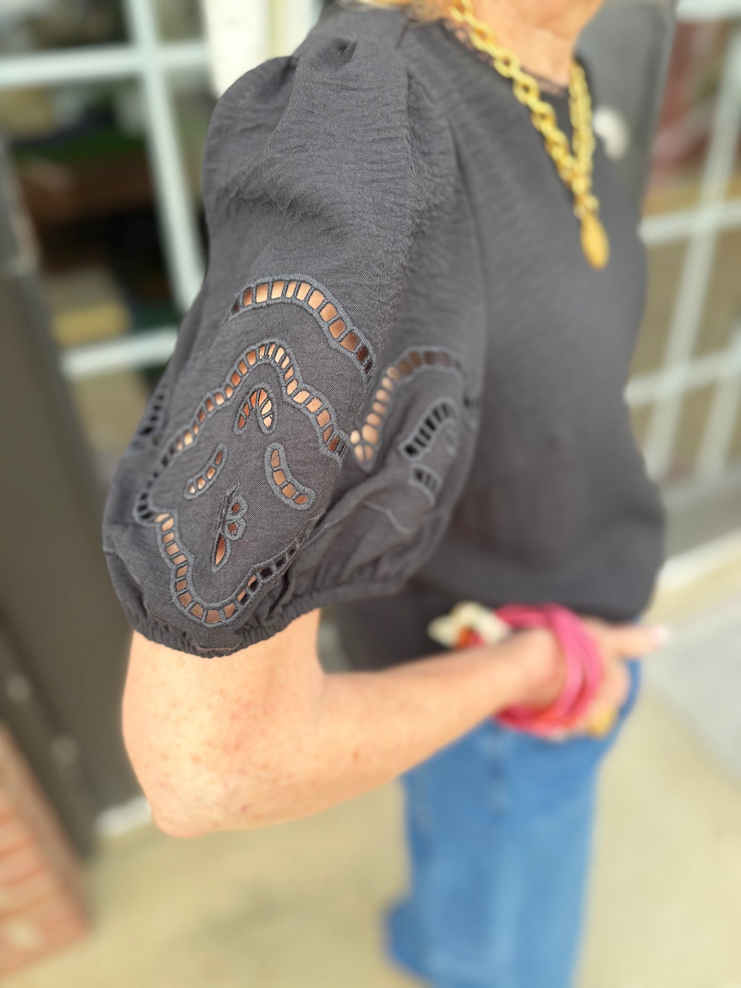 Haley Black Top with puffed, embroidered eyelet sleeves. Available in sizes XS-XL.