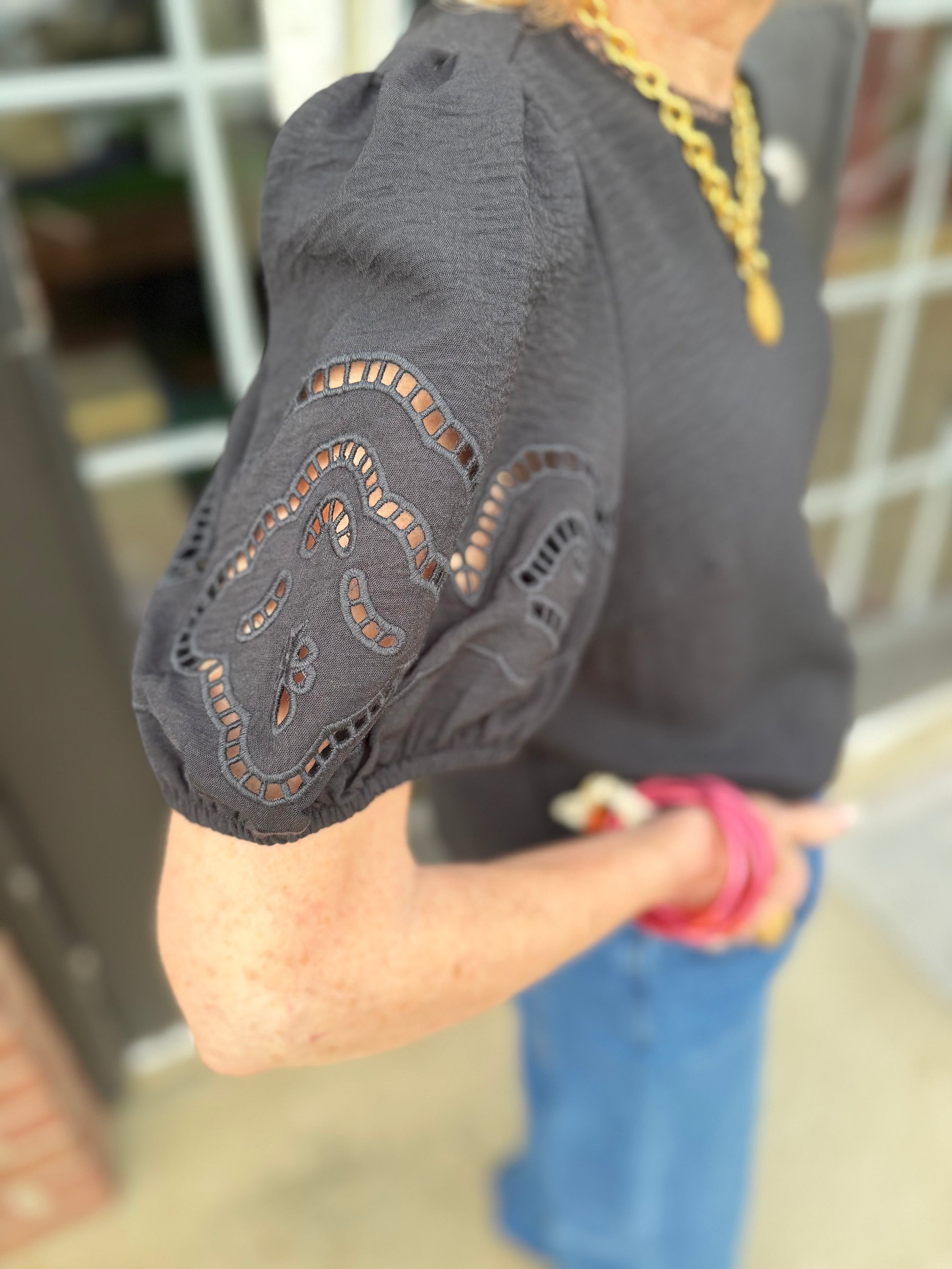 Haley Black Top with puffed, embroidered eyelet sleeves. Available in sizes XS-XL.