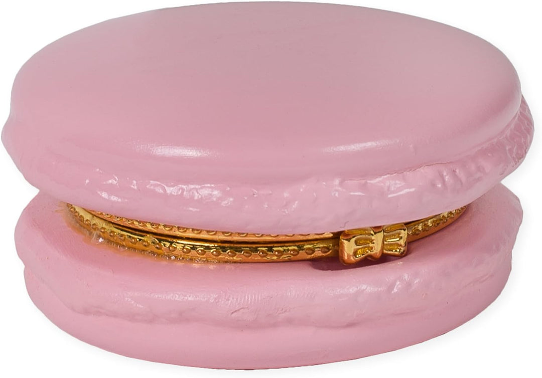 This product is a decorative, ceramic trinket box, designed to resemble a colorful Macaron Limoge. Highlighted with intricate detailing and complete with an ornate gold clasp. Crafted to mimic the form of miniature storage boxes, it adds a charming touch to any decor setting.