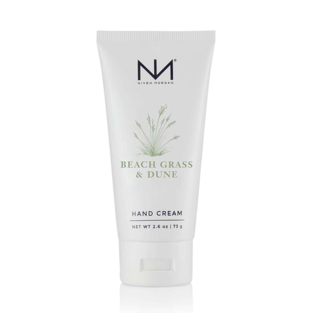 White tube of Beach Grass &amp; Dune Travel Hand Cream, grass design, flip-top, 2.6 oz (75 g), with organic aloe vera.