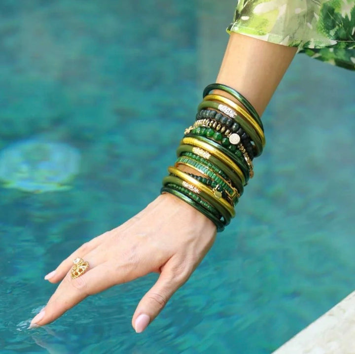Frond All Weather Bangles in green and gold, featuring an elegant waterproof design; available in sizes small, medium, large.