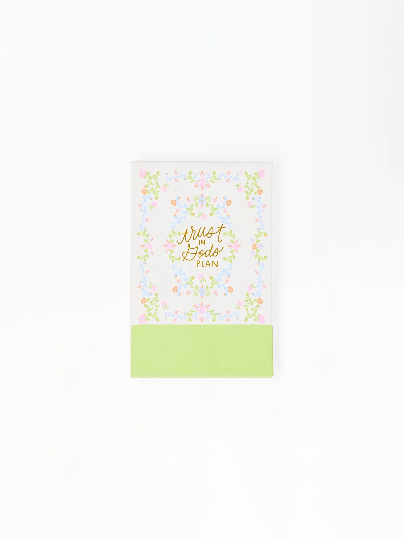 Compact notepad with white cover, gold "Trust in God's Plan" script, floral border, green bottom band; available in one size.