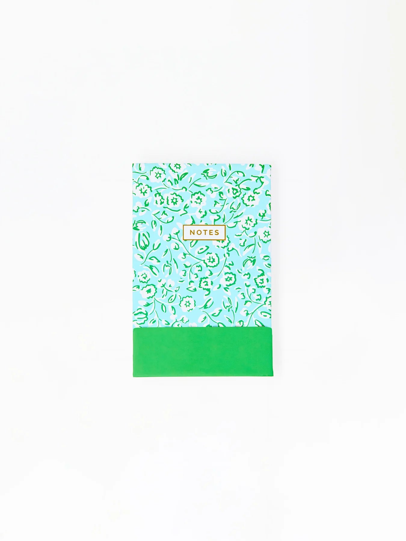 Compact notepad with light blue and green floral cover, "NOTES" in yellow-bordered box, solid green bottom. Sizes available.