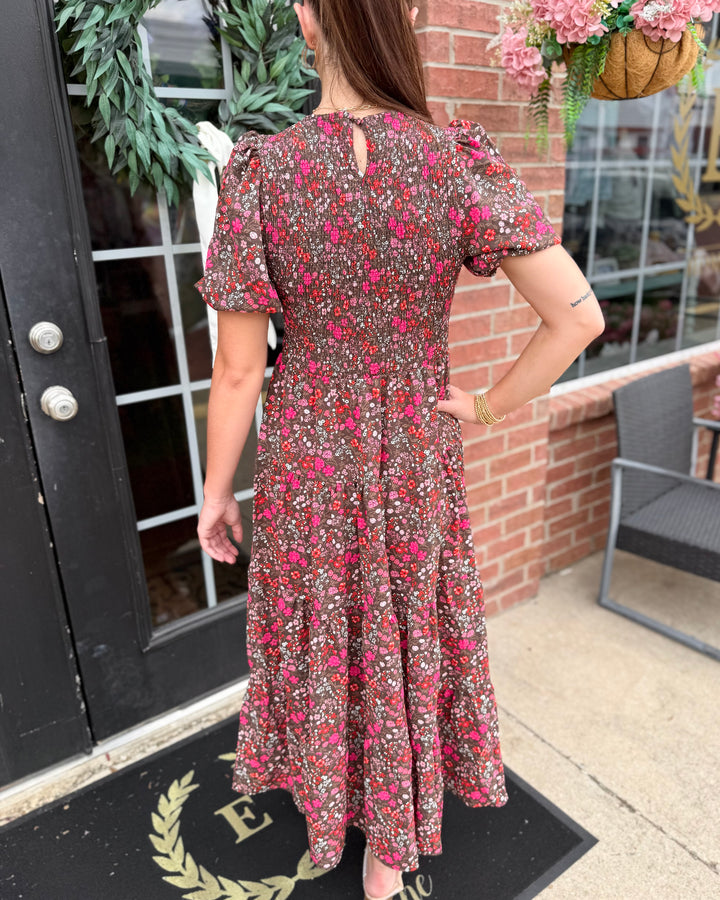 Lucille Granada Glen Cocoa Dress: floral print with pink and red flowers, smocked bodice. Available in sizes XS–XL.