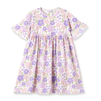 Eco-friendly knee-length dress, short sleeves, ruffled details, pastel floral print. Available in sizes XS–XL.