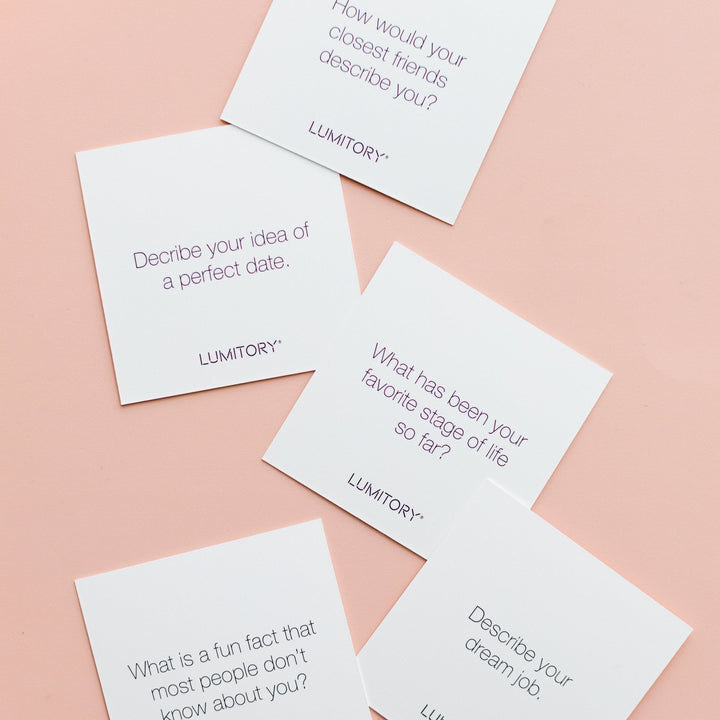 Set of five white "Conversation Cards Girls Night" with unique questions and LUMITORY logo. Available in standard size.