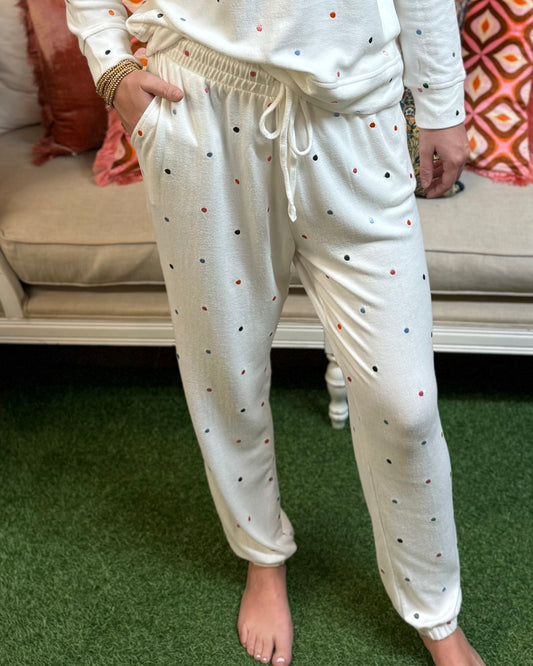 Sophie Confetti Dot Jogger Set: white joggers and matching long-sleeve top with multicolor confetti dots. Available in sizes XS-XL.