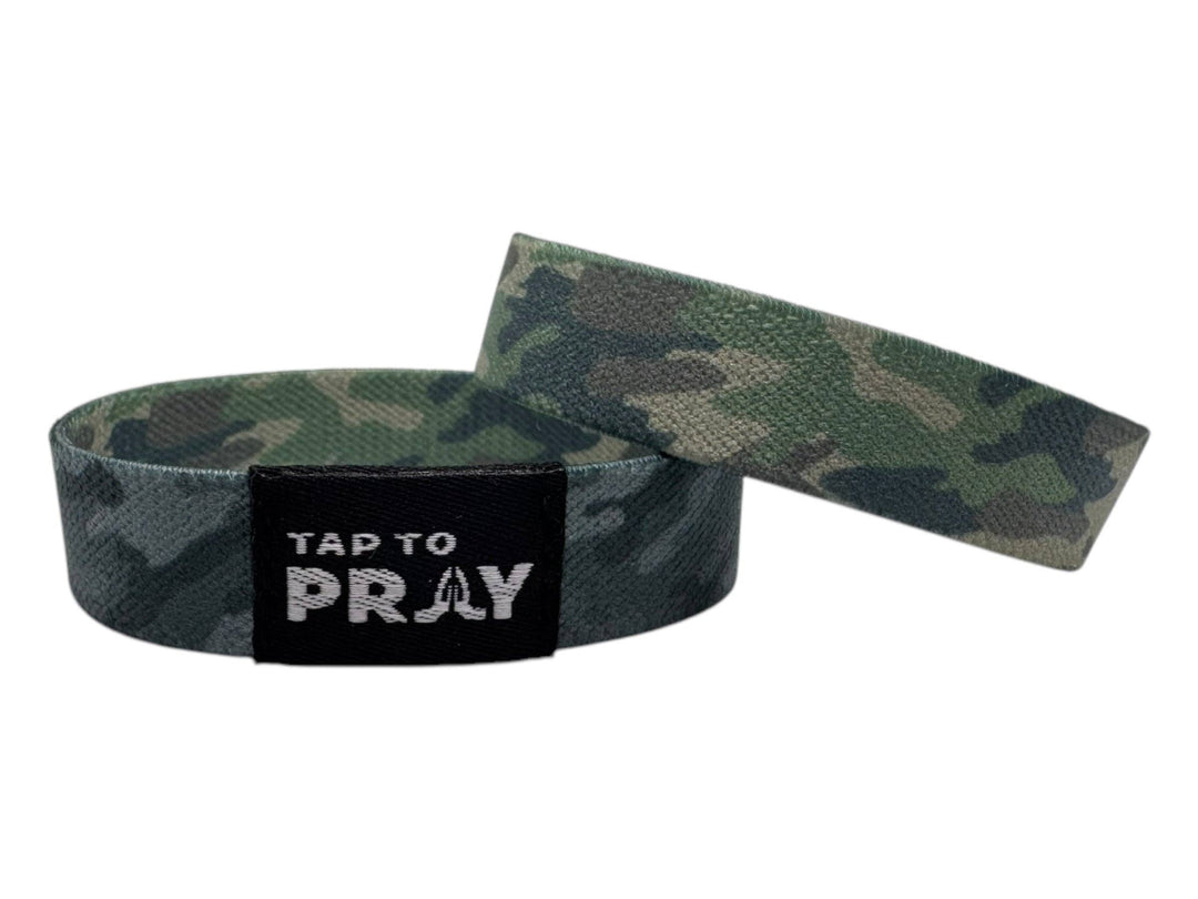 Two Tap To Pray™ Wristbands in green and charcoal camo with black "TAP TO PRAY" label. Available sizes: S, M, L.