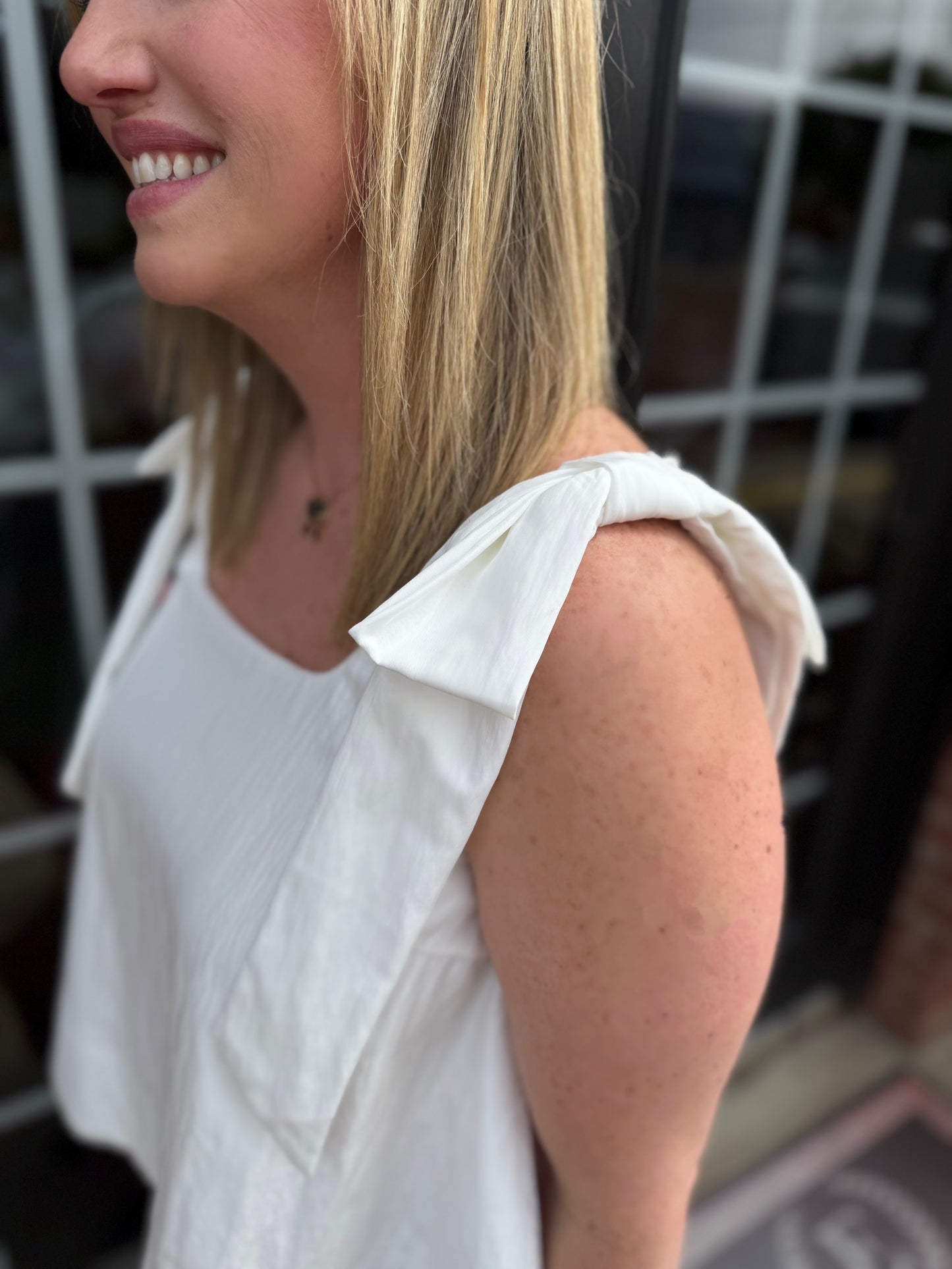White Scoop Neck Bow Shoulder Top with a stylish neckline and bow straps. Available in sizes XS–XL.