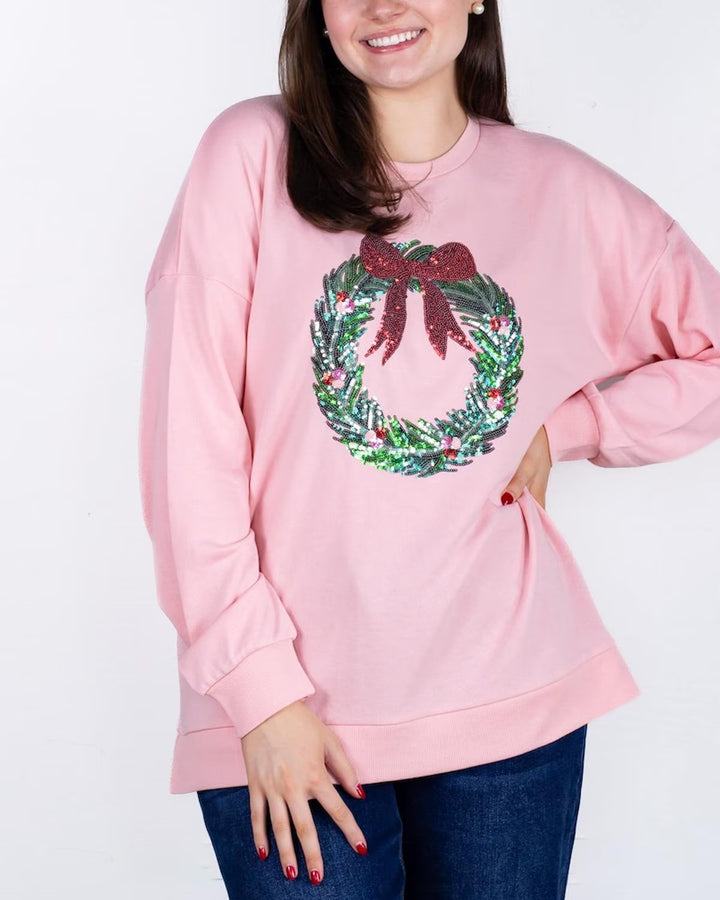 Clara Wreath Sequin Sweatshirt: pink, features a sequin wreath and red bow on the front. Available in sizes XS–XL.