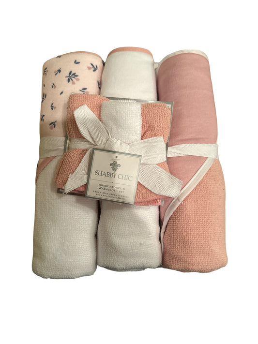 A bundle of Shabby Chic Washcloths and Hooded Towel Set in shades of pink and white, tied with a ribbon and a label, against a white background.