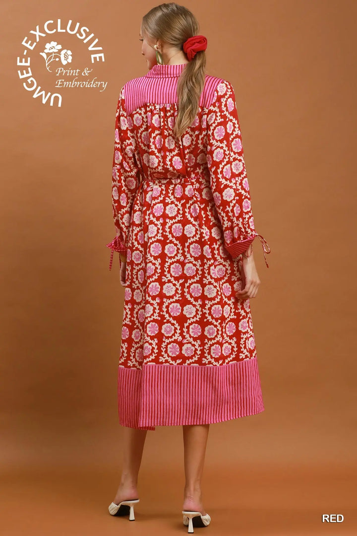 Mixed Media Print Midi Dress with collared neckline, red and pink floral print, long sleeves with tie cuffs, and striped hem. Available in multiple sizes.