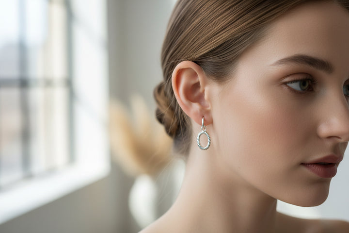 Oval silver drop earrings with a twisted rope design; available in small, medium, and large sizes.