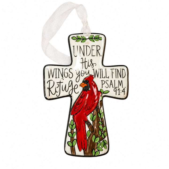 Cross-shaped hanging ornament with a red cardinal on a branch, featuring text “UNDER His WINGS you WILL FIND Refuge PSALM 91:4” and a white ribbon hanger.