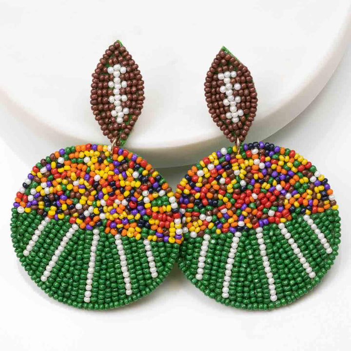 Football Field Beaded Earrings: round, multicolored beads, brown and white leaf-shaped top. Sizes available: small, medium.