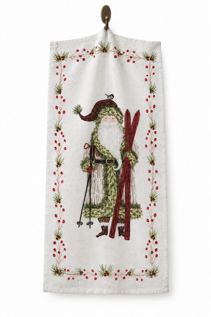 Cotton Printed Tea Towel with Santa &amp; Berries featuring Santa with skis and a border of pine needles and red berries.