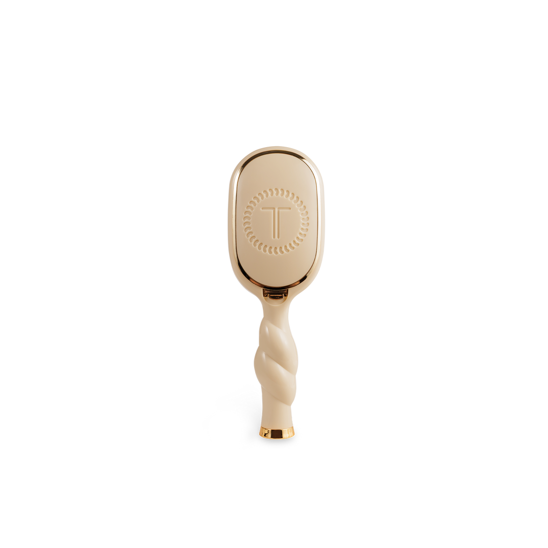 Mini Detangler Brush for Medium Hair in tan with twisted handle, gold accents, circular pattern, embossed "T". Sizes: mini.