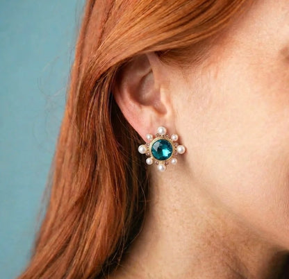 Circle Burst Stud Earrings: large pearl studs with a blue-green central gem, encircled by small pearls. Available in small, medium, and large sizes.