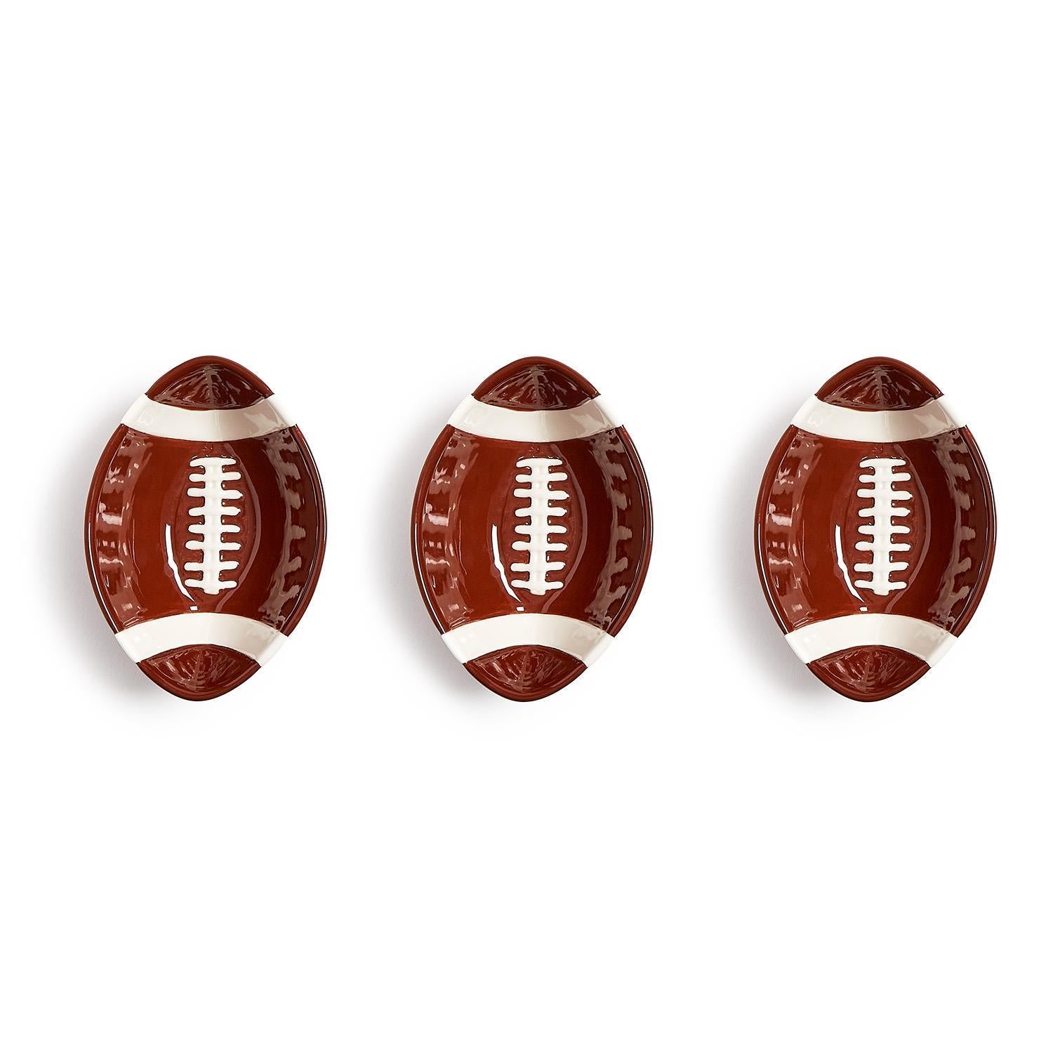 Set of three oval ceramic bowls designed to resemble American footballs, ideal for serving snacks on game day. Available sizes: small (6″), medium (8″), and large (10″).