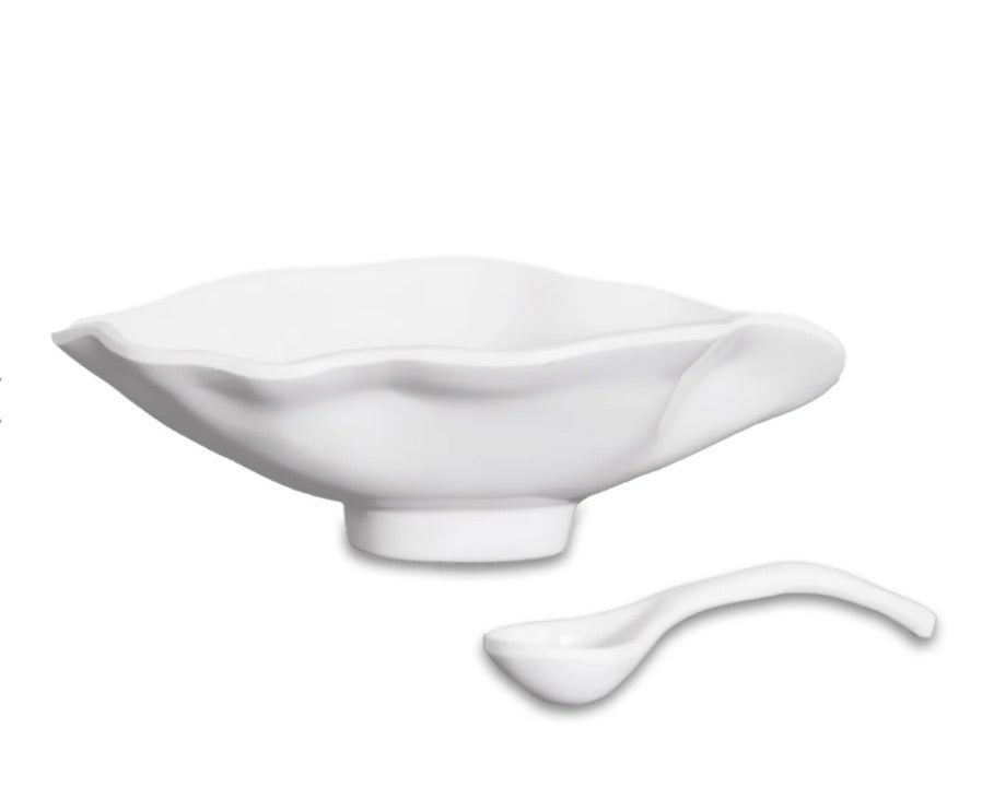 White ceramic oval bowl with smooth, glossy finish and wavy, petal-inspired rim; includes matching small spoon. Available in small size.