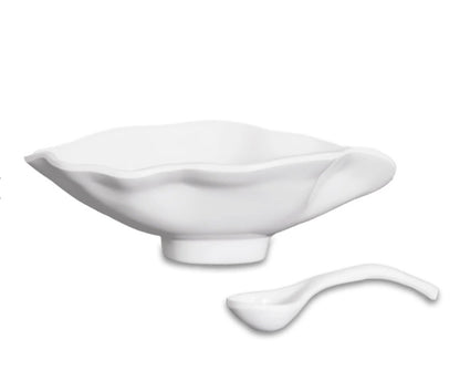 White ceramic oval bowl with smooth, glossy finish and wavy, petal-inspired rim; includes matching small spoon. Available in small size.