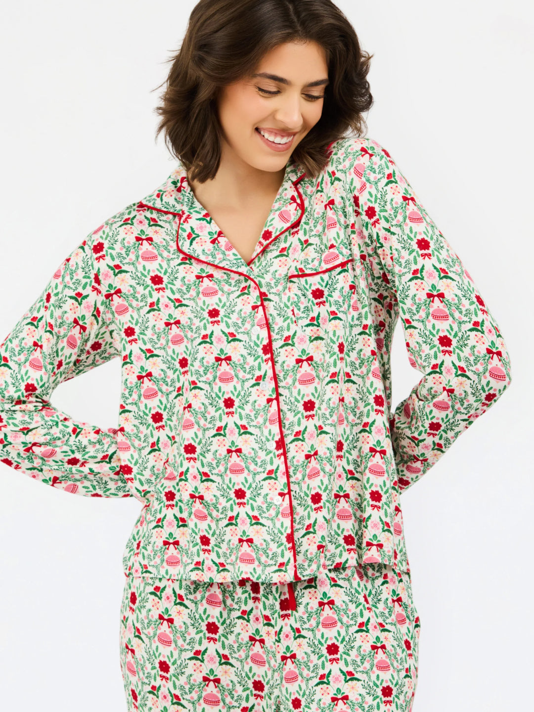 Charlotte Trimmed with Joy Pants Set featuring a long-sleeve button-down pajama top and pants in a modal blend with a red and green Christmas ornament and floral print, finished with red piping. Available in multiple sizes.