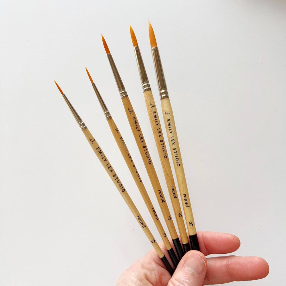 Watercolor Paintbrush: Size 0, wooden handle labeled "Emily Lex Studio," synthetic taklon bristles. Sizes available.