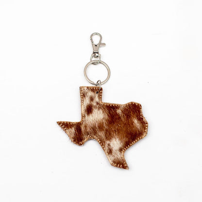 Texas Hide Keychain Clip in brown and white cowhide, visible stitching, silver keyring and clasp. Sizes: Small, Medium.