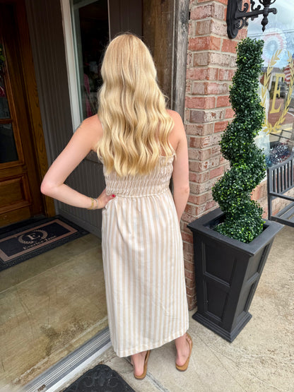Taupe Striped Spaghetti Strap Midi Dress available in sizes XS-XL. Features a fitted bodice and midi length.