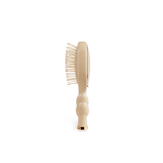 Mini Detangler Brush for Medium Hair in tan with gold-tipped handle. Available in mini size only.