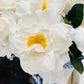 Elegant lifelike Artificial Real Touch Orlane Rose-15" Long: Pure White with bright yellow centers, arranged in a blue and white porcelain vase.