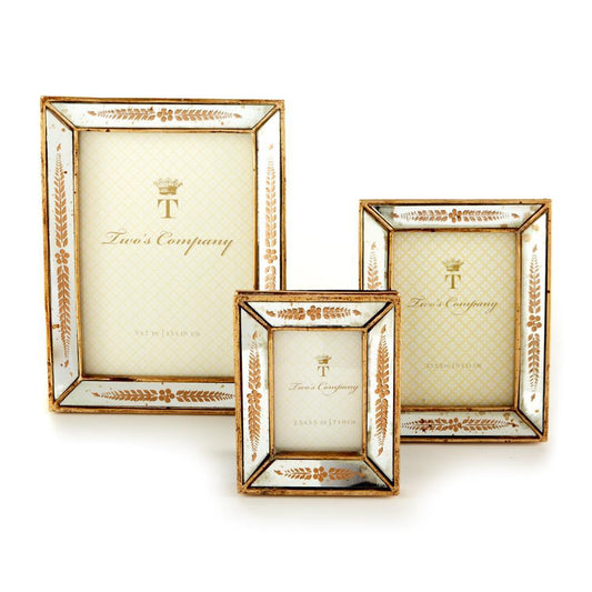 Three Verona Gold Leaf Mirror Photo Frames. Timeless design with distressed gold and white finish. Ornate leafy pattern reminiscent of gold leaf mirror frames. Contains beige insert with "Two’s Company" text and decorative accents.

Available sizes: 
- Small
- Medium
- Large