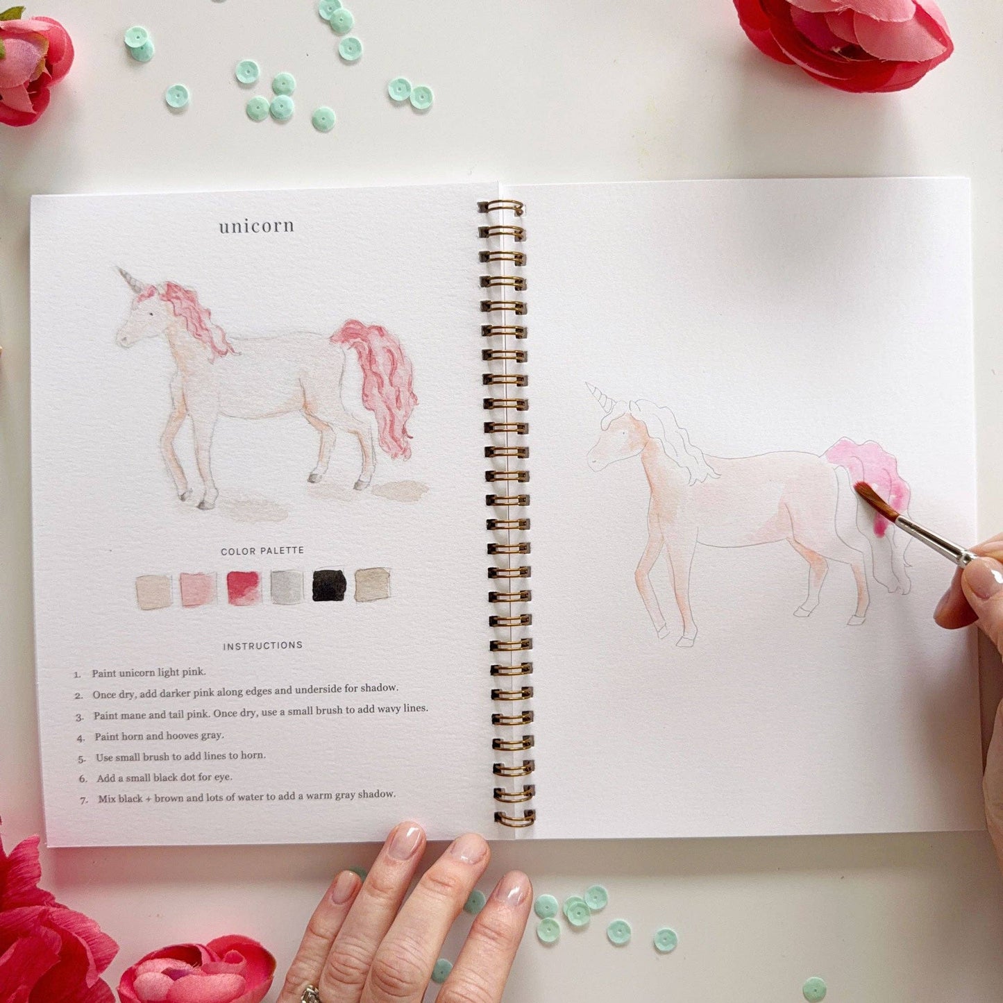 Open Fairytale Watercolor Workbook with unicorn painting instructions and color palette. Available in standard workbook size.
