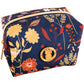 Small navy blue essentials bag with yellow, red, and orange floral pattern, gold emblem, zipper; sizes available.