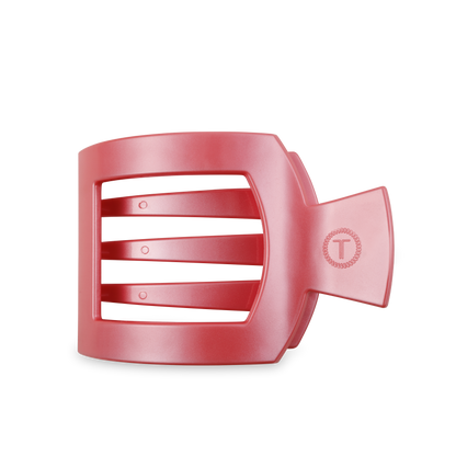 Red plastic hair clip with strong grip, three horizontal slits, and "T" emblem. Available sizes: medium, large.